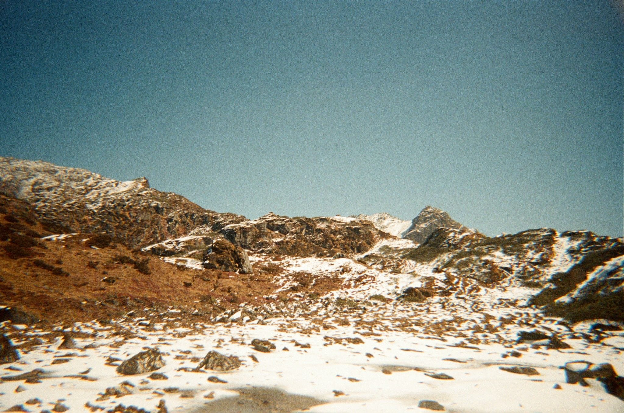 Snowy mountain landscape under a clear blue sky